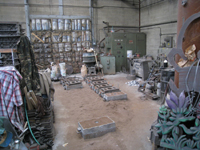 Fence -- Swiss Foundry -- view of foundry from other direction with newly poured molds in front.