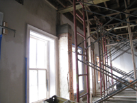 Second Floor--Central (large) room showing brown plaster and column preparation - December 28, 2010