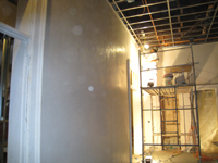 Second Floor--Applying final plaster coat in northeast room - January 7, 2011