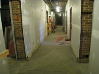 Ground Floor--New concrete floors and drywall in corridor looking east - February 1, 2011