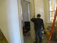 First Floor--Scraping and repairing door frames in corridor on east end - March 3, 2011