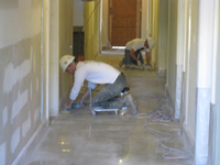 Ground Floor (Basement) --Workers polishing the concrete corridor floor - April 29, 2011