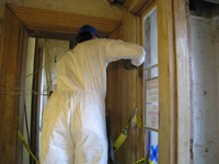 First Floor -- Workers sanding door frame next to north door - September 8, 2010