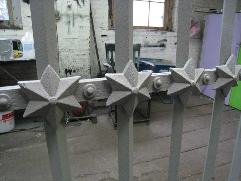 Fence - at G. Krug and Sons - detail of stars and horizontal bar after repair and priming.