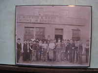 Fence - at G. Krug and Sons - 1880's photo of workers at G. Krug with Gustav Krug framed in doorway.