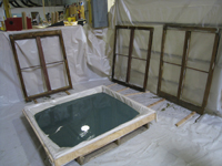 Windows and Doors - SRS Corp. -- wood preservative bath being used prior to final sanding and priming.