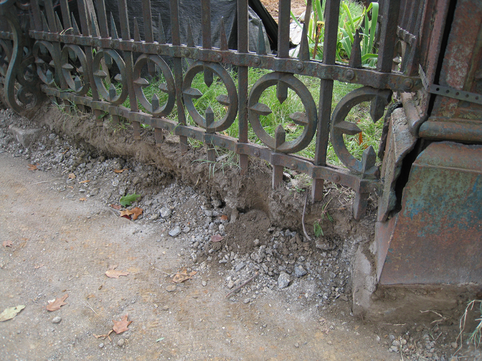 Fence--Detail--Removal of cement from bottom of fence on Pennsylvania Ave. side