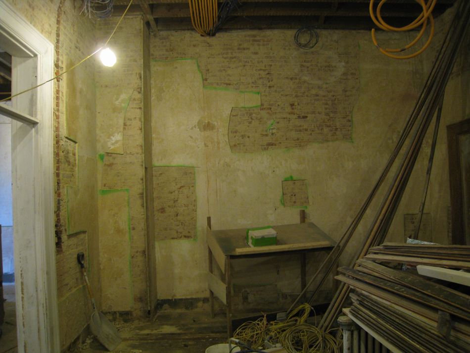 Second Floor--Northeast room--West wall.  Selective baring of wall for plaster replacement and restoration