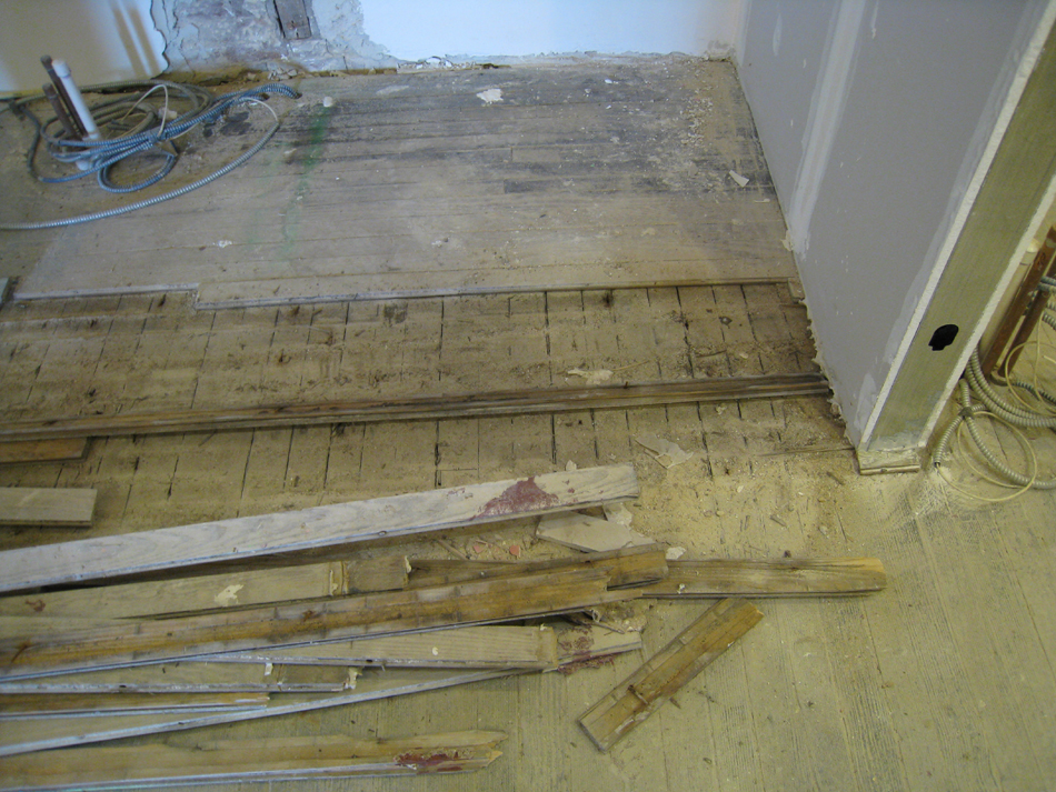 Second Floor--Northwest corner room with original floor exposed after removing later floor (top) - January 20, 2011