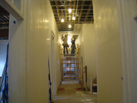 Second Floor--Installing drywall on the ceiling in the central corridor (looking west) - March 15, 2011